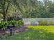 Shady backyard with grill and white picket fence, offering a private outdoor space at 149 Daniels Ridge Dr, Summerville, SC 29485