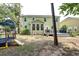 Spacious backyard featuring a playset, slide, and a patio, creating an ideal outdoor retreat for Gathering and relaxation at 149 Daniels Ridge Dr, Summerville, SC 29485