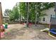 Spacious backyard with mature trees, offering a private outdoor area for relaxation and play with play set, slide, and trampoline at 149 Daniels Ridge Dr, Summerville, SC 29485
