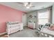 Bright Bedroom with pink accents, a crib, a rocking chair, and a plush carpet at 149 Daniels Ridge Dr, Summerville, SC 29485