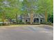 Beautiful community clubhouse surrounded by lush landscaping and mature trees with nearby playground at 149 Daniels Ridge Dr, Summerville, SC 29485
