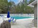 Relaxing community pool with lounge chairs and umbrellas surrounded by lush greenery at 149 Daniels Ridge Dr, Summerville, SC 29485
