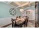 Elegant dining room with coffered ceilings, wainscoting and a stylish chandelier at 149 Daniels Ridge Dr, Summerville, SC 29485
