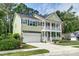 Charming home with a two-story facade, manicured lawn, attached garage, and inviting front porch, offering classic suburban appeal at 149 Daniels Ridge Dr, Summerville, SC 29485