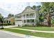 Beautifully landscaped home with a double porch, green lawn, and a two-car garage at 149 Daniels Ridge Dr, Summerville, SC 29485