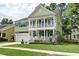 Charming two-story home featuring a double porch, well-manicured lawn, and lush landscaping at 149 Daniels Ridge Dr, Summerville, SC 29485