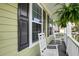 Cozy front porch with rocking chairs, black shutters, and ample sunshine at 149 Daniels Ridge Dr, Summerville, SC 29485