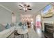 Bright living room features a fireplace, ceiling fan, and smooth flow into the kitchen at 149 Daniels Ridge Dr, Summerville, SC 29485