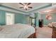 Bright main bedroom featuring a tray ceiling, ceiling fan, and large flat screen television at 149 Daniels Ridge Dr, Summerville, SC 29485