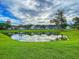 Picturesque pond view reflecting homes and landscaping, creating a serene and inviting community atmosphere at 149 Daniels Ridge Dr, Summerville, SC 29485