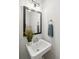 Powder room featuring a pedestal sink, vanity mirror, decorative plants, and a towel ring at 153 Heritage Cir # K3, Mount Pleasant, SC 29464
