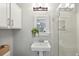 Bathroom featuring a pedestal sink, vanity mirror, decorative plants, a towel, and a glass shower at 153 Heritage Cir # K3, Mount Pleasant, SC 29464