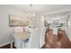 Bright dining area with a chandelier and hardwood floors, with a view into the kitchen at 153 Heritage Cir # K3, Mount Pleasant, SC 29464