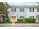 Charming townhome with light blue siding, black shutters, tidy landscaping, and a peach-colored front door at 153 Heritage Cir # K3, Mount Pleasant, SC 29464