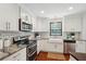 Modern kitchen featuring white cabinets, granite countertops, stainless steel appliances, and a farmhouse sink at 153 Heritage Cir # K3, Mount Pleasant, SC 29464