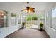 Bright sunroom featuring neutral carpet, white walls, many windows, and sliding glass doors to a patio at 153 Heritage Cir # K3, Mount Pleasant, SC 29464