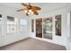 Bright sunroom featuring neutral carpet, white walls, many windows, and sliding glass doors to interior at 153 Heritage Cir # K3, Mount Pleasant, SC 29464