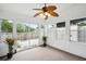 Bright sunroom featuring neutral carpet, white walls, many windows, and sliding glass doors to a patio at 153 Heritage Cir # K3, Mount Pleasant, SC 29464