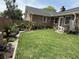 A well-maintained backyard shows the yard, garden area and the exterior of the home at 1606 Waterside Blvd, Moncks Corner, SC 29461