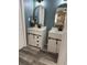 Stylish bathroom features a double vanity, wood-look flooring, and elegant shiplap wall paneling for a luxurious feel at 1606 Waterside Blvd, Moncks Corner, SC 29461