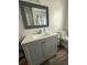 Bathroom with modern gray vanity, decorative mirror, and a shower/tub combo at 1606 Waterside Blvd, Moncks Corner, SC 29461