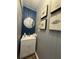 Stylish powder room features a modern sink, shiplap wall design, and attractive artwork for a unique look at 1606 Waterside Blvd, Moncks Corner, SC 29461