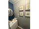 Charming powder room with a pedestal sink, accent wall, and modern light fixture offering comfort and style at 1606 Waterside Blvd, Moncks Corner, SC 29461
