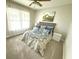 Cozy bedroom with carpeted floors, natural light, and a beautifully decorated bed at 1606 Waterside Blvd, Moncks Corner, SC 29461
