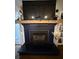 Living room fireplace with dark paint, wooden mantel and neutral accents at 1606 Waterside Blvd, Moncks Corner, SC 29461