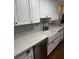 Bright kitchen features subway tile backsplash, quartz counters, stainless appliances, and farmhouse sink at 1606 Waterside Blvd, Moncks Corner, SC 29461