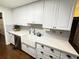 Stylish kitchen with white cabinets, farmhouse sink, quartz countertops, and stainless dishwasher at 1606 Waterside Blvd, Moncks Corner, SC 29461
