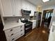 Modern kitchen with white cabinets, quartz countertops, and stainless steel appliances at 1606 Waterside Blvd, Moncks Corner, SC 29461