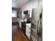 Modern kitchen featuring white cabinets, quartz countertops, stainless steel appliances, and hardwood floors at 1606 Waterside Blvd, Moncks Corner, SC 29461