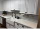 Bright kitchen featuring white cabinets, quartz countertops, and farmhouse sink at 1606 Waterside Blvd, Moncks Corner, SC 29461