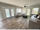 Open-concept living room features hardwood floors, ceiling fan, and a gray sofa and ottoman at 1606 Waterside Blvd, Moncks Corner, SC 29461