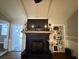 Living room features a fireplace with dark blue mantle, wooden beam, and mounted TV at 1606 Waterside Blvd, Moncks Corner, SC 29461