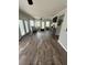 Open-concept living room features hardwood floors, ceiling fan, and a gray sofa and ottoman at 1606 Waterside Blvd, Moncks Corner, SC 29461