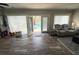Bright living room showcasing wood floors, recliner, and patio access to the sparkling pool at 1606 Waterside Blvd, Moncks Corner, SC 29461