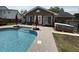 Backyard oasis boasts a beautiful pool, surrounding patio, and well-maintained lawn for outdoor enjoyment at 1606 Waterside Blvd, Moncks Corner, SC 29461