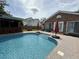 Private backyard pool with a bar area for entertaining and lush greenery for a relaxing atmosphere at 1606 Waterside Blvd, Moncks Corner, SC 29461