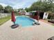 Inviting outdoor pool area featuring a bar, lush greenery, and ample patio space for entertaining at 1606 Waterside Blvd, Moncks Corner, SC 29461