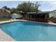 A serene pool area with a poolside bar and lush landscaping, perfect for outdoor entertaining and relaxation at 1606 Waterside Blvd, Moncks Corner, SC 29461