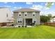 An inviting backyard featuring a well-maintained lawn and stylish patio with outdoor seating and a grill at 167 Cherry Grove Dr, Summerville, SC 29483