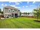 Large backyard featuring a well-maintained lawn, a patio with outdoor furniture, and a wooden fence at 167 Cherry Grove Dr, Summerville, SC 29483