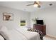 Bedroom featuring neutral walls, white beddings, a wood ceiling fan and dark wood dresser with TV at 167 Cherry Grove Dr, Summerville, SC 29483