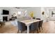 Bright dining area with a weathered wood table, gray upholstered chairs, and views into the living area at 167 Cherry Grove Dr, Summerville, SC 29483
