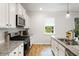 Modern kitchen featuring white cabinets, stainless steel appliances, granite countertops and light wood floors at 167 Cherry Grove Dr, Summerville, SC 29483