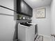 A laundry room with white appliances and dark cabinets and shelving at 167 Cherry Grove Dr, Summerville, SC 29483