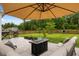 A cozy patio area with comfortable seating around a fire pit, perfect for outdoor entertaining at 167 Cherry Grove Dr, Summerville, SC 29483