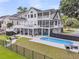 Aerial view of the home with a luxurious pool, patio, and fire pit in the fenced backyard at 1711 Indigo Island Dr, Hanahan, SC 29410